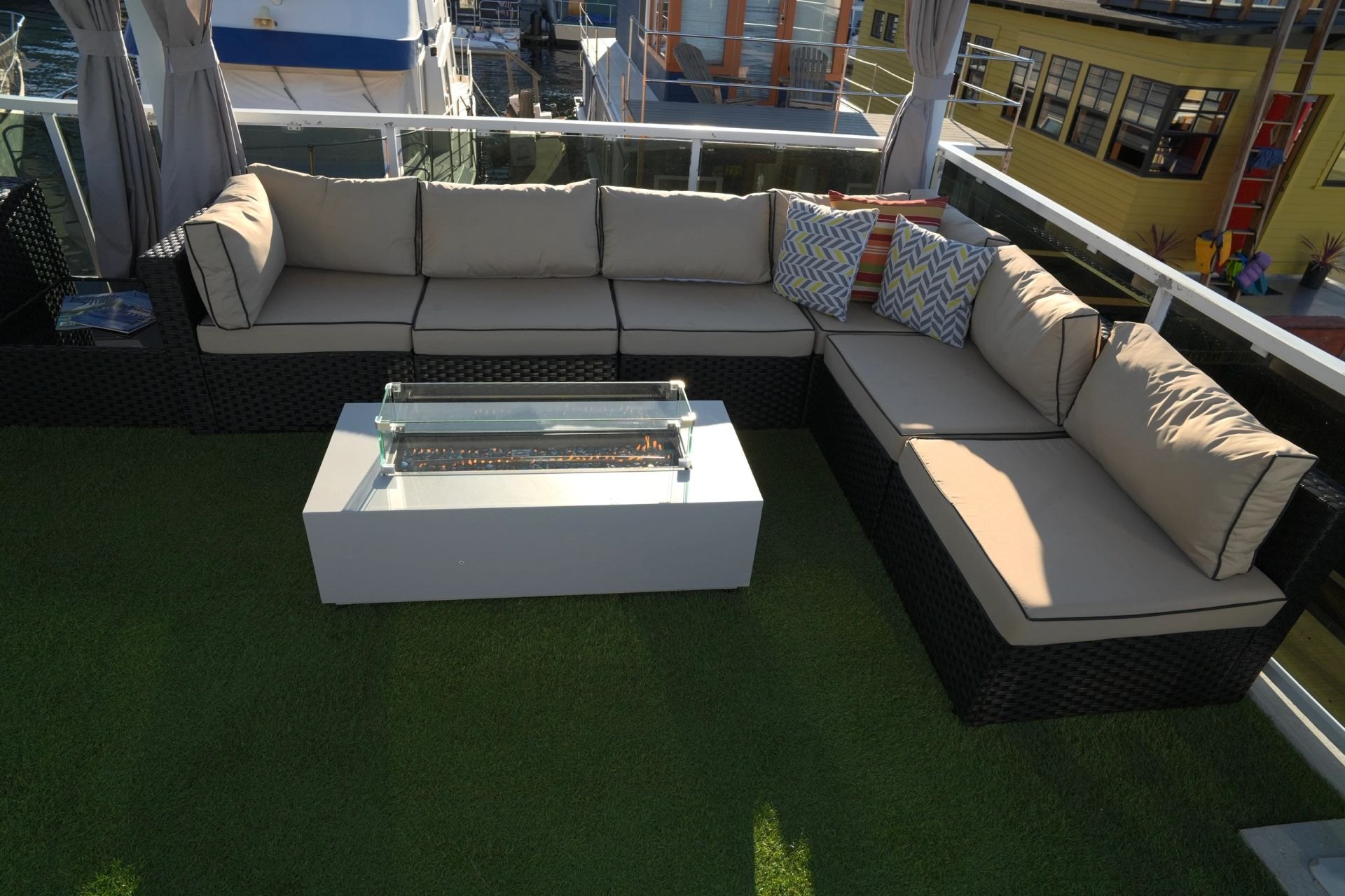 Upper-deck lounge at night with the gas fire table lit, overlooking Lake Union